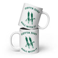 White coffee mug with an illustration of two rolled marijuana joints holding hands with the caption "Gotta Just Roll With It".