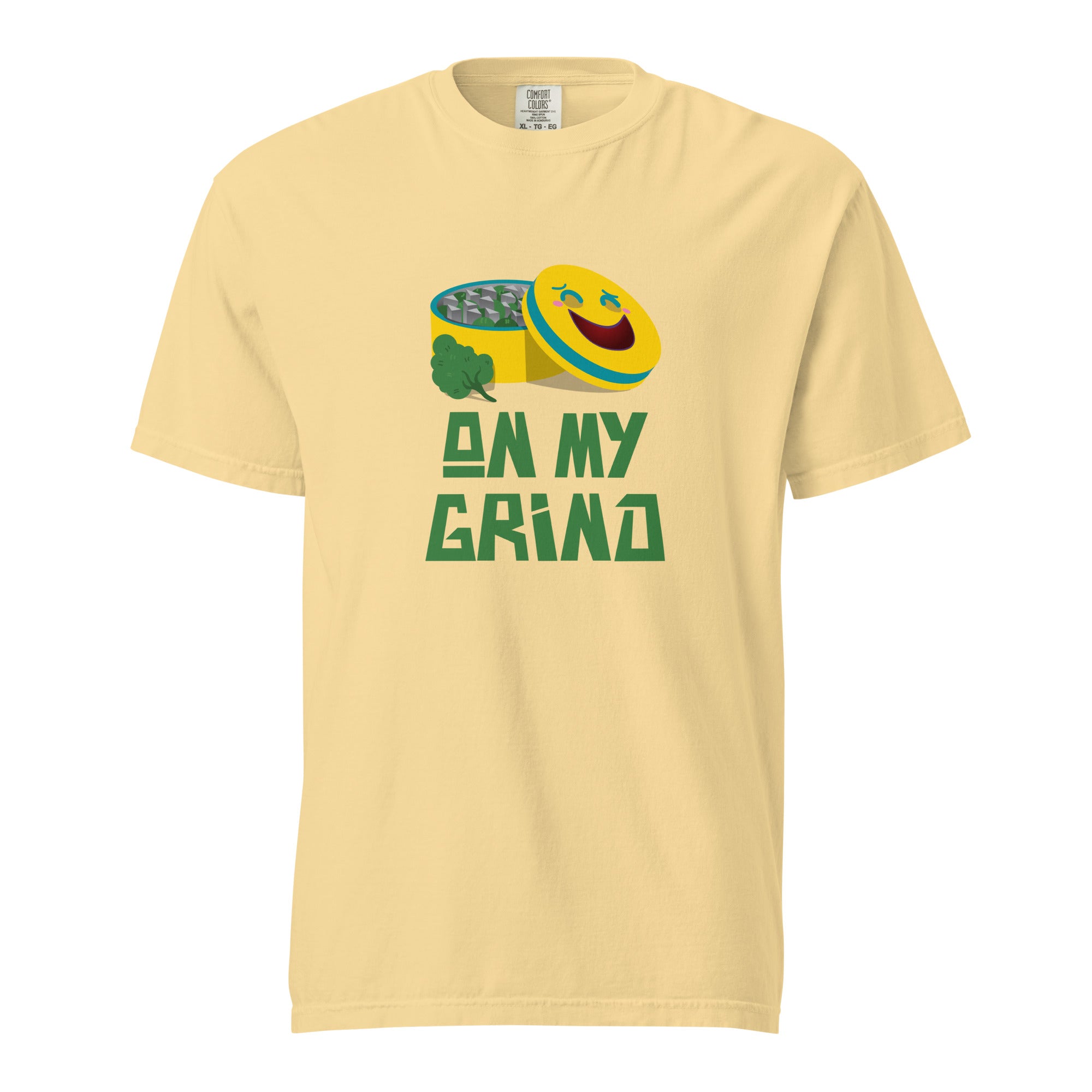 Yellow t-shirt with an illustration of a marijuana grinder with a happy face on the lid with the caption "On My Grind".